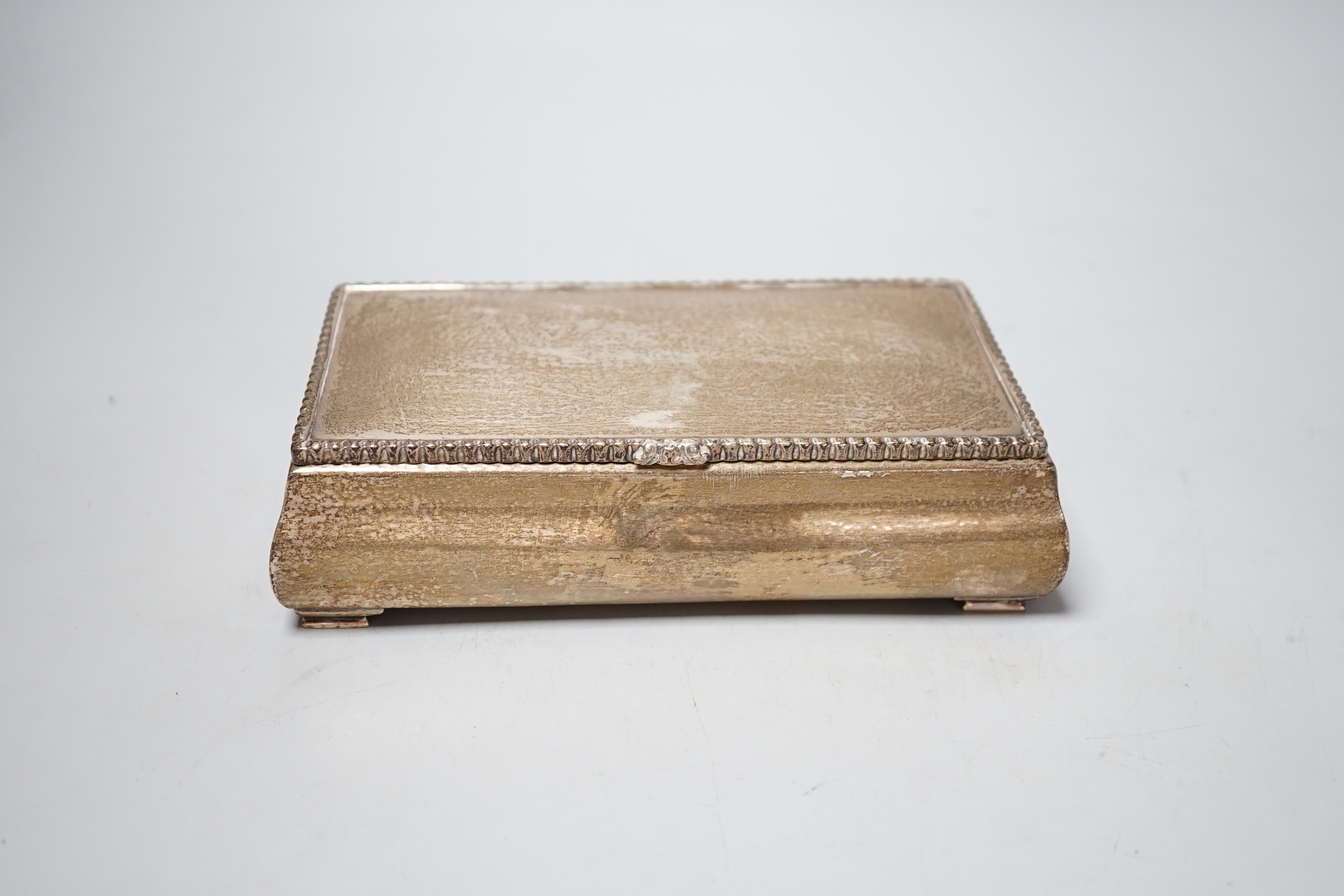 A George V hammered silver mounted rectangular cigarette box, Goldsmiths & Silversmiths Co Ltd, London, 1928, 18.5cm.